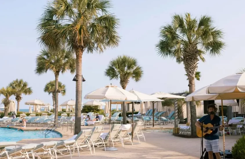 Cover image for Where to Stay On Kiawah Island blog, showing the pool and a live musician at The Sanctuary